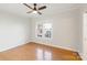 Bedroom with hardwood floors, a ceiling fan, and a window providing natural light at 215 Cedar St, Belmont, NC 28012