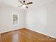 Bedroom features hardwood floors, neutral walls, a ceiling fan and a window with natural light at 215 Cedar St, Belmont, NC 28012