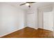 Bedroom features hardwood floors, neutral walls, a closet and a window with natural light at 215 Cedar St, Belmont, NC 28012