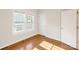 Well-lit bedroom with hardwood floors, double windows, and neutral paint for a cozy atmosphere at 215 Cedar St, Belmont, NC 28012