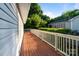Spacious deck with wood flooring and white railings, offering views of the surrounding landscape at 215 Cedar St, Belmont, NC 28012