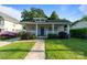 Charming home featuring a cozy front porch, stone walkway and a well-manicured lawn at 215 Cedar St, Belmont, NC 28012