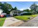 Charming home with a cozy front porch and a lush green lawn, complemented by a paved driveway at 215 Cedar St, Belmont, NC 28012