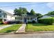 Charming home with a welcoming front porch, lush lawn, and stone walkway leading to the entrance at 215 Cedar St, Belmont, NC 28012