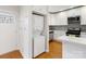Modern kitchen featuring white cabinets, stainless steel appliances, and a convenient washer/dryer combo at 215 Cedar St, Belmont, NC 28012