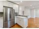 Bright kitchen features stainless steel appliances, white cabinets, mosaic tile backsplash and hardwood floors at 215 Cedar St, Belmont, NC 28012