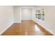 Bright and airy living room featuring beautiful hardwood floors and abundant natural light through large windows at 215 Cedar St, Belmont, NC 28012