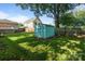 The backyard features a practical shed and a spacious lawn, providing ample storage and outdoor space at 215 Cedar St, Belmont, NC 28012