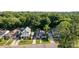 Charming homes line a street with mature trees creating a lush, green canopy at 215 Cedar St, Belmont, NC 28012