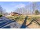 A well-maintained brick home featuring a long driveway and expansive front lawn on a sunny day at 220 Augusta Dr, Statesville, NC 28625