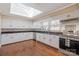 Bright kitchen featuring white cabinetry, stainless steel appliances, and a well-placed skylight at 220 Augusta Dr, Statesville, NC 28625