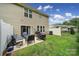 Nice backyard showcasing a patio set, grill with cover, and well-maintained lawn at 2203 Whitford Ln, Charlotte, NC 28210