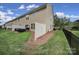 Fenced yard features patio with outdoor seating, well-kept grass, and a peaceful ambiance at 2203 Whitford Ln, Charlotte, NC 28210
