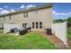 Backyard featuring a patio set, grill, sliding glass door, and green lawn at 2203 Whitford Ln, Charlotte, NC 28210