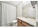 Cozy bathroom featuring a shower with curtain, granite countertop vanity, and a framed mirror at 2203 Whitford Ln, Charlotte, NC 28210