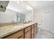 Bathroom features a granite countertop, double vanity, large mirror and tiled flooring at 2203 Whitford Ln, Charlotte, NC 28210