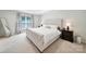 Serene bedroom with a tufted headboard bed, tray ceiling, and stylish bedside tables with lamps at 2203 Whitford Ln, Charlotte, NC 28210