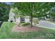 Charming exterior of a house featuring stone accents, a garage, and landscaped yard at 2203 Whitford Ln, Charlotte, NC 28210