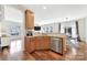 Modern kitchen featuring stainless steel dishwasher and sink, granite countertops, and open view into dining and living room at 2203 Whitford Ln, Charlotte, NC 28210