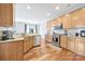 Bright kitchen with stainless steel appliances, granite counters, wooden cabinets, and hardwood floors at 2203 Whitford Ln, Charlotte, NC 28210