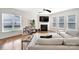 Bright living room with a fireplace, hardwood floors, large windows, and a view of the outdoors at 2203 Whitford Ln, Charlotte, NC 28210