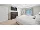 Main bedroom with a large dresser, TV, ceiling fan and ensuite bathroom access at 2203 Whitford Ln, Charlotte, NC 28210