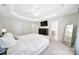Bright main bedroom featuring a tray ceiling, ceiling fan and ensuite bathroom at 2203 Whitford Ln, Charlotte, NC 28210
