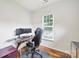Functional office space with a glass desk, monitor setup, and comfortable black office chair at 2203 Whitford Ln, Charlotte, NC 28210