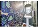 Unique powder room featuring modern wallpaper, a pedestal sink, stylish lighting and modern decor at 2203 Whitford Ln, Charlotte, NC 28210