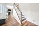 Elegant staircase featuring hardwood steps with white risers and railing, leading to upper level at 2203 Whitford Ln, Charlotte, NC 28210