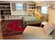 Cozy bedroom showcasing a large area rug, shelving, and a comfortable seating area for relaxation at 2314 Wolfe St, Charlotte, NC 28205