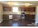 Well-lit kitchen featuring stainless steel appliances, dark cabinetry, and granite countertops at 2440 Mint Thistle Ct, Charlotte, NC 28269