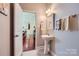Stylish bathroom featuring a pedestal sink and tile flooring at 2630 Filson Ct, Charlotte, NC 28214