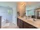 Bright bathroom with double sinks, a soaking tub, and a separate shower at 2630 Filson Ct, Charlotte, NC 28214