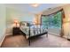 Comfortable bedroom featuring a wrought iron bed frame and bright window at 2630 Filson Ct, Charlotte, NC 28214