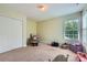 Comfortable bedroom with cozy chair, closet, and window at 2630 Filson Ct, Charlotte, NC 28214