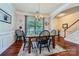 Bright dining room with hardwood floors, decorative trim, and an elegant chandelier fixture at 2630 Filson Ct, Charlotte, NC 28214