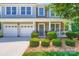 Attractive two-story home featuring a covered porch, stone accents, well-maintained landscaping, and a two-car garage at 2630 Filson Ct, Charlotte, NC 28214