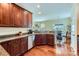 Modern kitchen showcasing dark wood cabinetry, granite countertops, stainless steel appliances, and hardwood flooring at 2630 Filson Ct, Charlotte, NC 28214