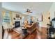 Cozy living room featuring hardwood floors, fireplace, and large windows providing natural light at 2630 Filson Ct, Charlotte, NC 28214