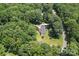 Aerial view of wooded acreage with charming home featuring mature trees and an expansive lawn at 267 Winthrow Creek Rd, Mooresville, NC 28115