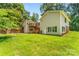 A spacious backyard displaying the home's deck with stairs, exterior, and lush green lawn at 267 Winthrow Creek Rd, Mooresville, NC 28115