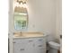 This half-bath features a decorative mirror, modern vanity, and an elongated toilet at 267 Winthrow Creek Rd, Mooresville, NC 28115