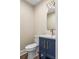 Stylish powder room with navy vanity, gold hardware, and an arch mirror at 267 Winthrow Creek Rd, Mooresville, NC 28115