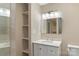 Bright bathroom featuring a single vanity, open shelving and a large, well lit mirror at 267 Winthrow Creek Rd, Mooresville, NC 28115