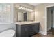 Elegant bathroom featuring a double vanity, custom mirror, and glass block window for natural light at 267 Winthrow Creek Rd, Mooresville, NC 28115