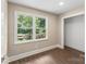 This bedroom has hardwood floors, a window overlooking the front yard, and neutral walls at 267 Winthrow Creek Rd, Mooresville, NC 28115
