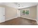 This bedroom boasts hardwood floors, a ceiling fan, and a window with natural light at 267 Winthrow Creek Rd, Mooresville, NC 28115
