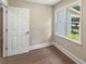 Bedroom with hardwood floors and a large window overlooking the side yard at 267 Winthrow Creek Rd, Mooresville, NC 28115