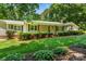 Charming one-story home boasts a covered porch with wooden columns and verdant landscaping at 267 Winthrow Creek Rd, Mooresville, NC 28115